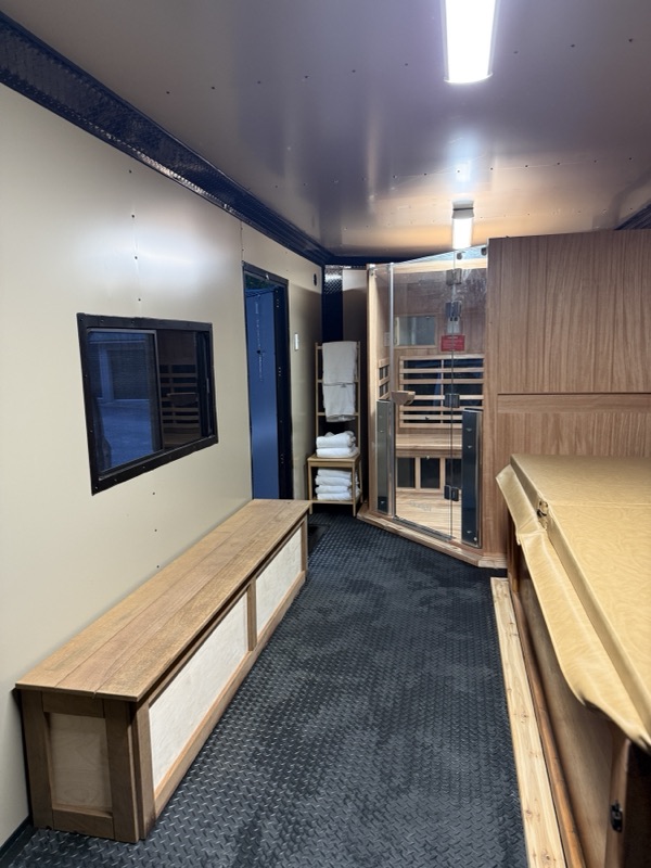 Sauna, cold plunge, and built-in bench seating with towels